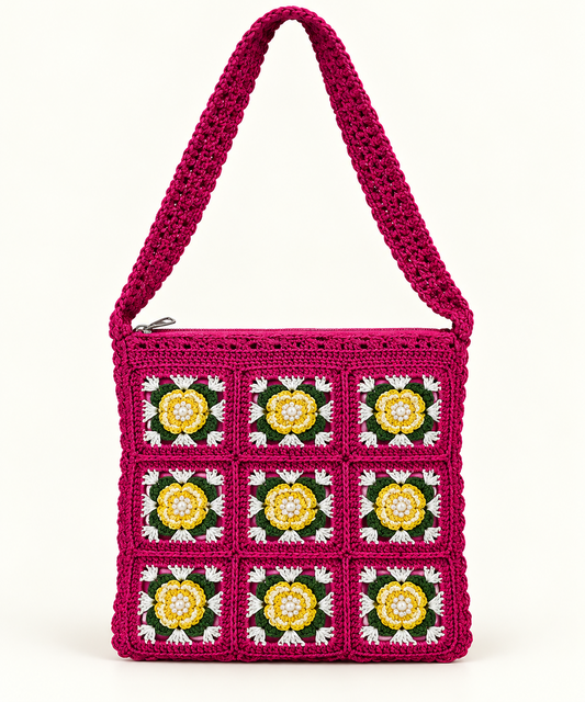 Vibrant magenta crochet shoulder bag with yellow and white floral granny squares